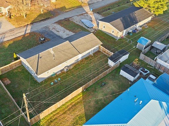 An aerial view of a residential area with houses and a blue roof.