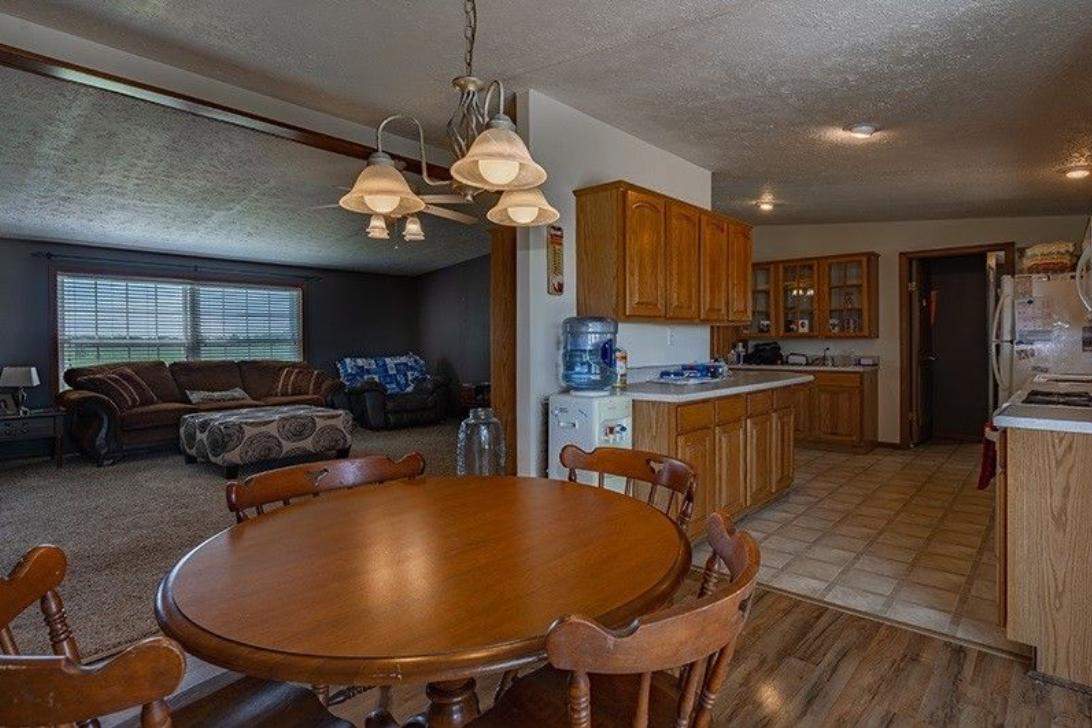 There is a table and chairs in the middle of the room.