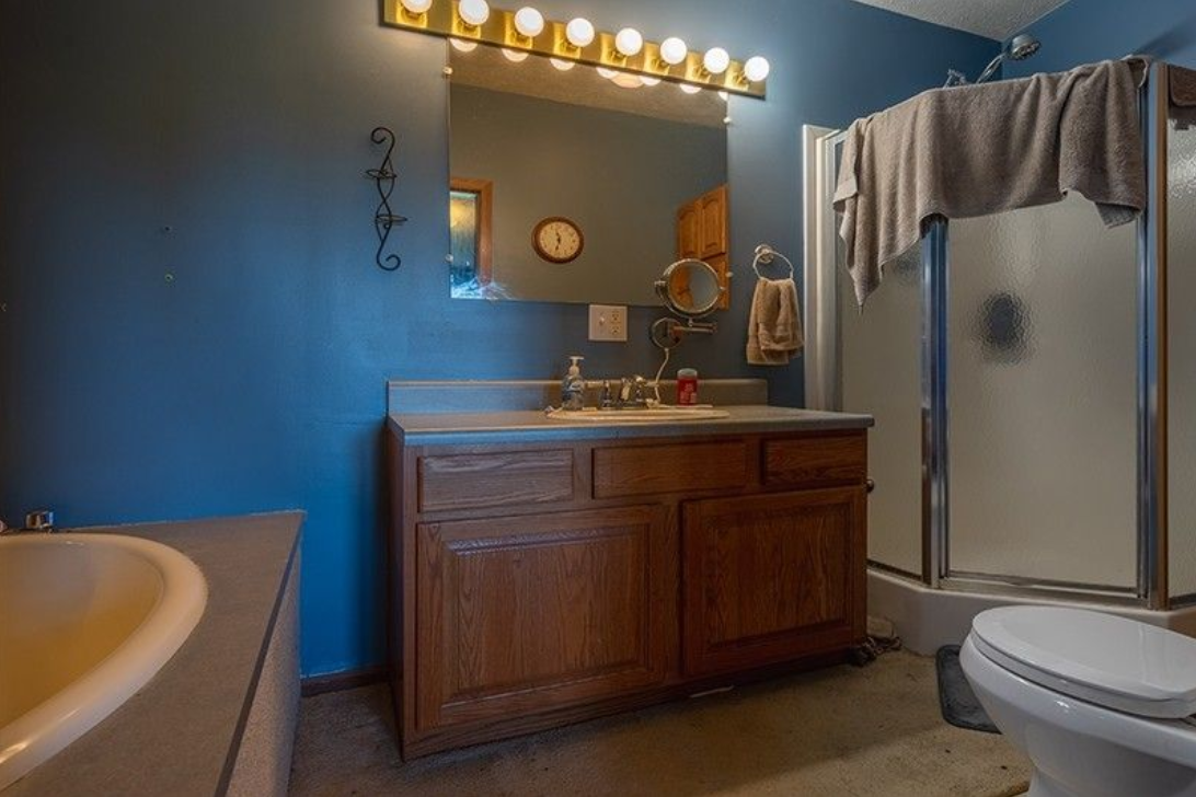 A bathroom with a sink , toilet , tub and shower.