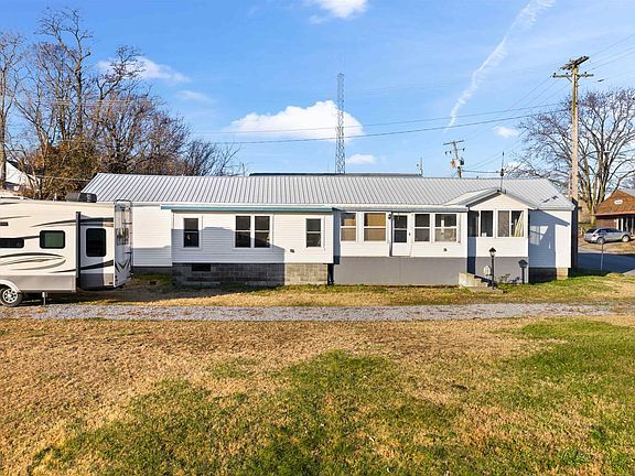 A mobile home with a rv parked in front of it.