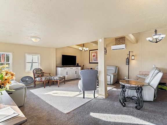 A living room filled with furniture and a television.