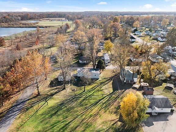 An aerial view of a residential area with a lake in the background.