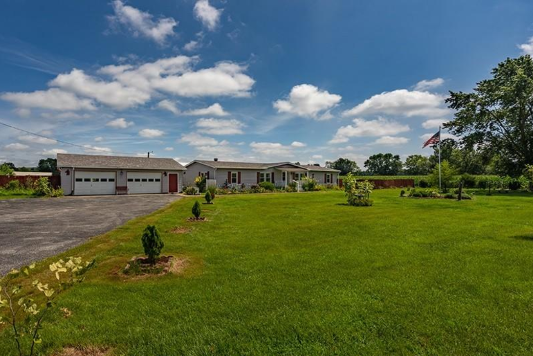 A large house with a large lawn in front of it.