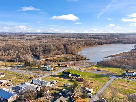 An aerial view of a small town next to a river.
