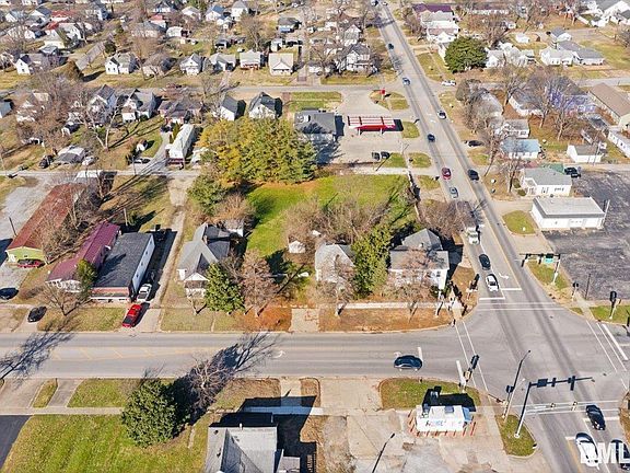 An aerial view of a residential area with a lot of houses and a street.