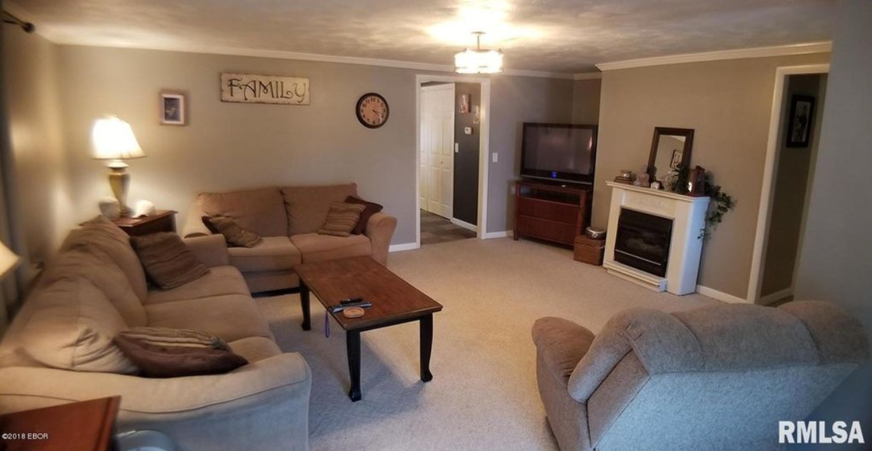 A living room with a fireplace and a couch