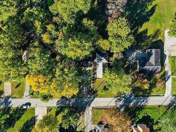 An aerial view of a residential neighborhood with trees and houses.