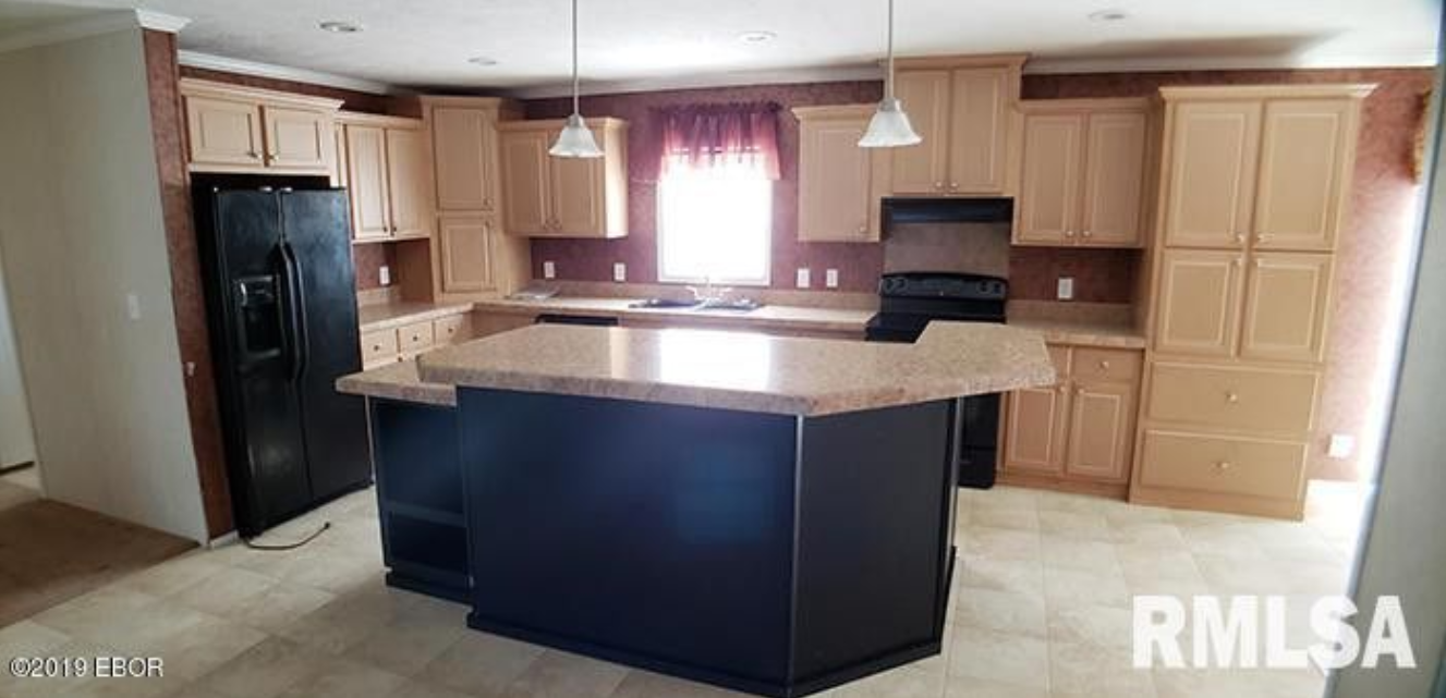A kitchen with a large island in the middle of it.