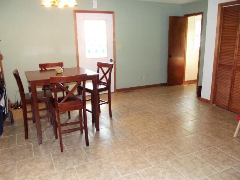 A dining room with a table and chairs in it