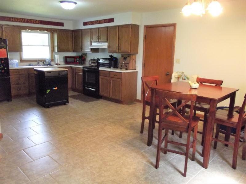 A kitchen with a table and chairs in it