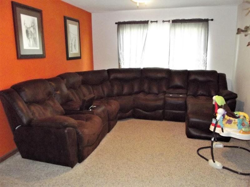 A living room with a large sectional couch