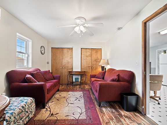 A living room with two couches and a ceiling fan.