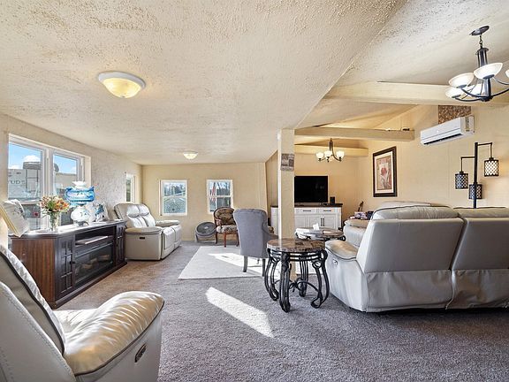 A living room filled with furniture and a television.