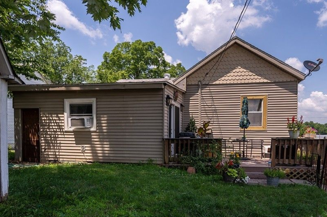 A small house with a satellite dish on the roof