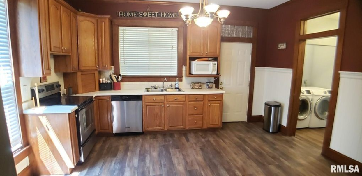 A kitchen with wooden cabinets and stainless steel appliances.