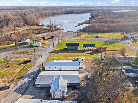 An aerial view of a small town with a river in the background.
