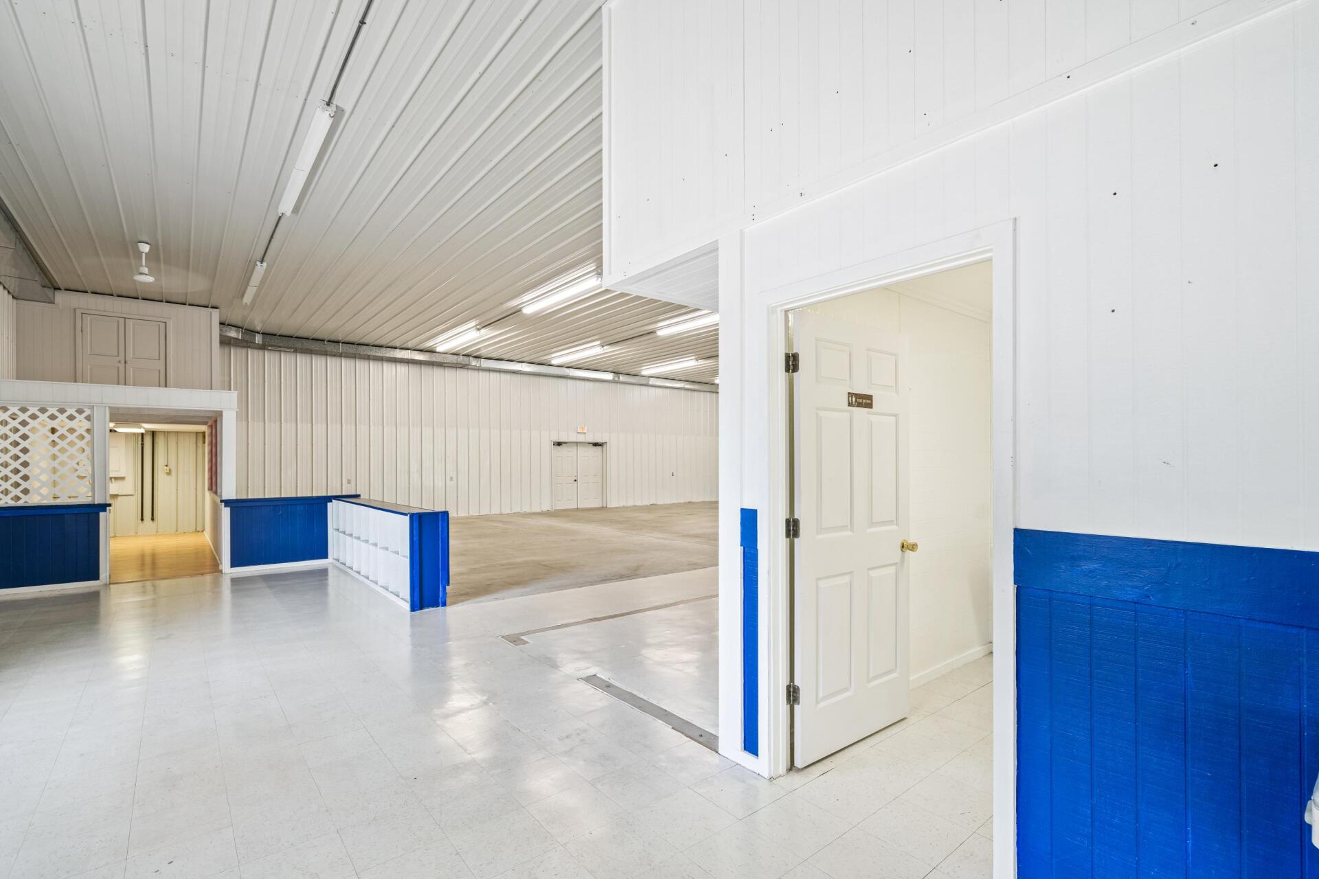 A large empty room with blue and white walls and a door.