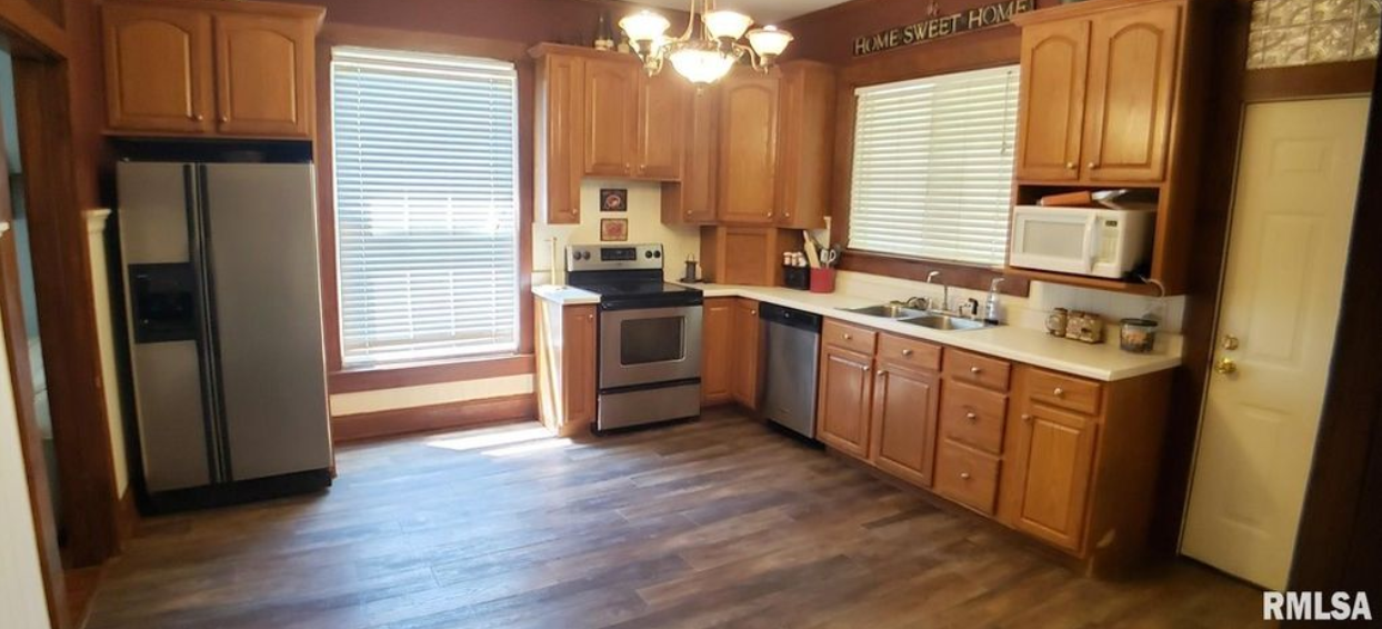 A kitchen with wooden cabinets and stainless steel appliances.