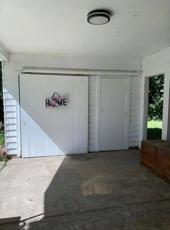 A white garage door with a sign on it that says `` home ''.