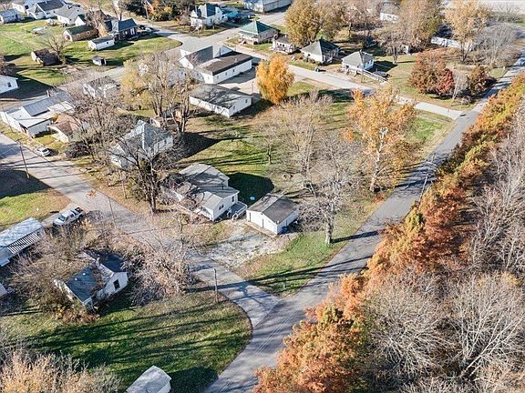 An aerial view of a residential neighborhood with trees and houses.