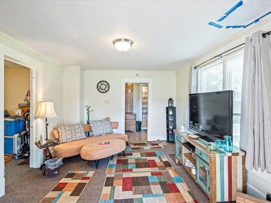 A living room with a couch and a flat screen tv
