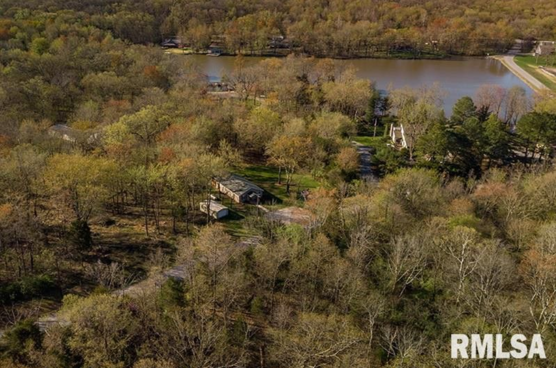 An aerial view of a lake surrounded by trees.