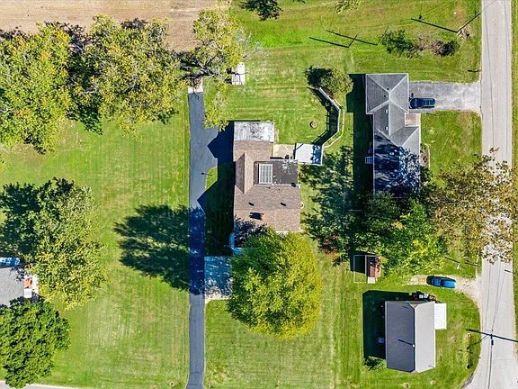 An aerial view of a house and a lot of grass.