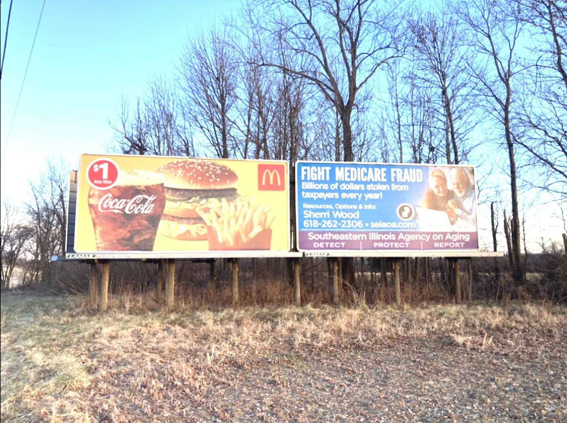A mcdonald 's billboard with a coca cola drink and a hamburger on it