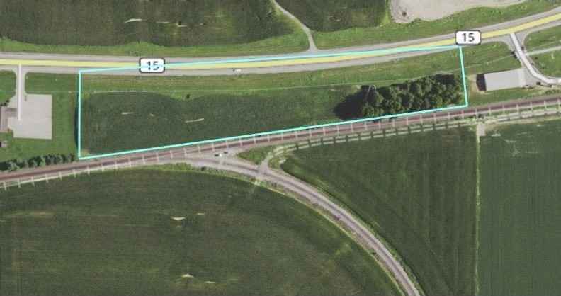 An aerial view of a train track and a road.