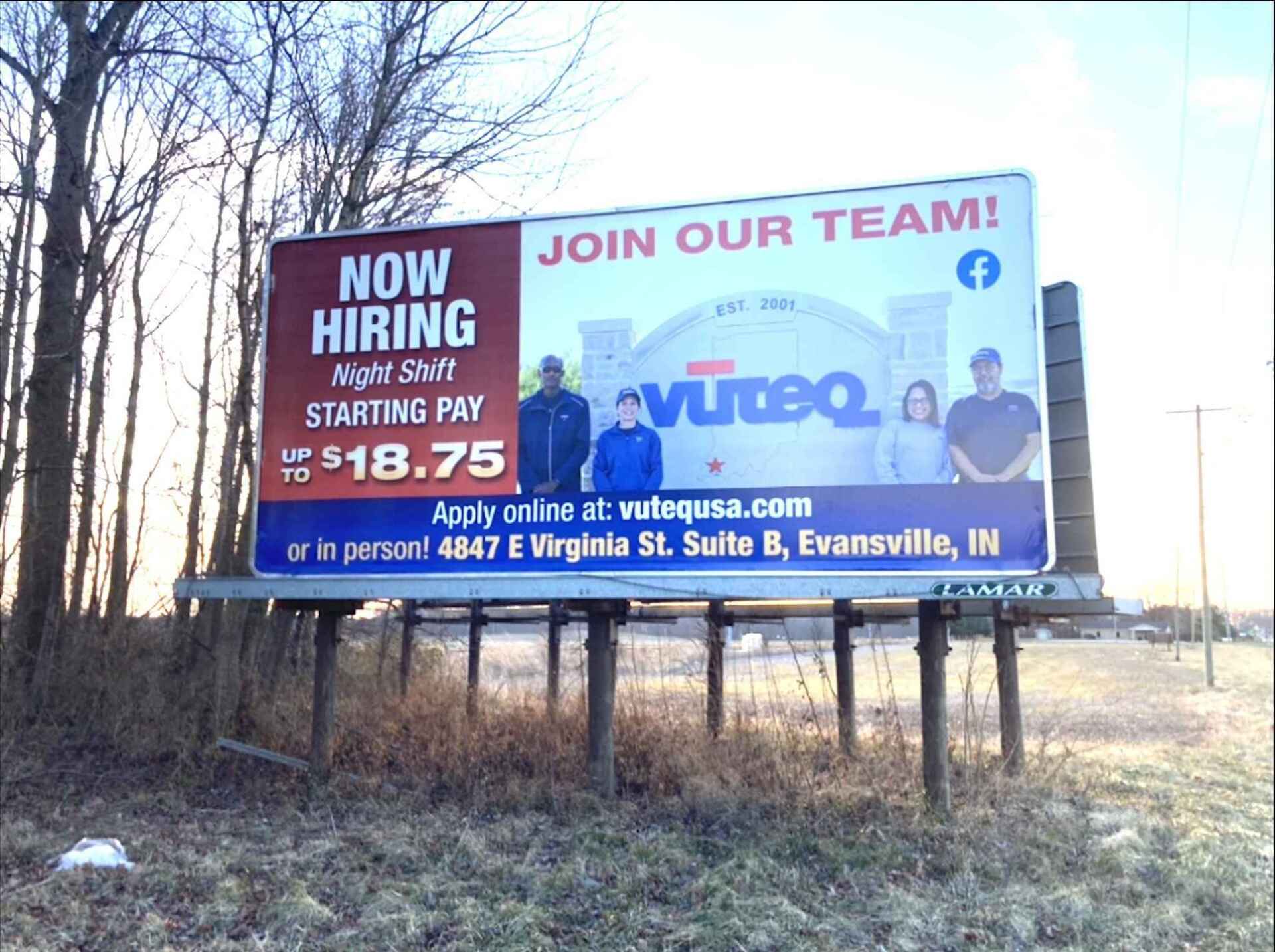 A billboard that says now hiring on it