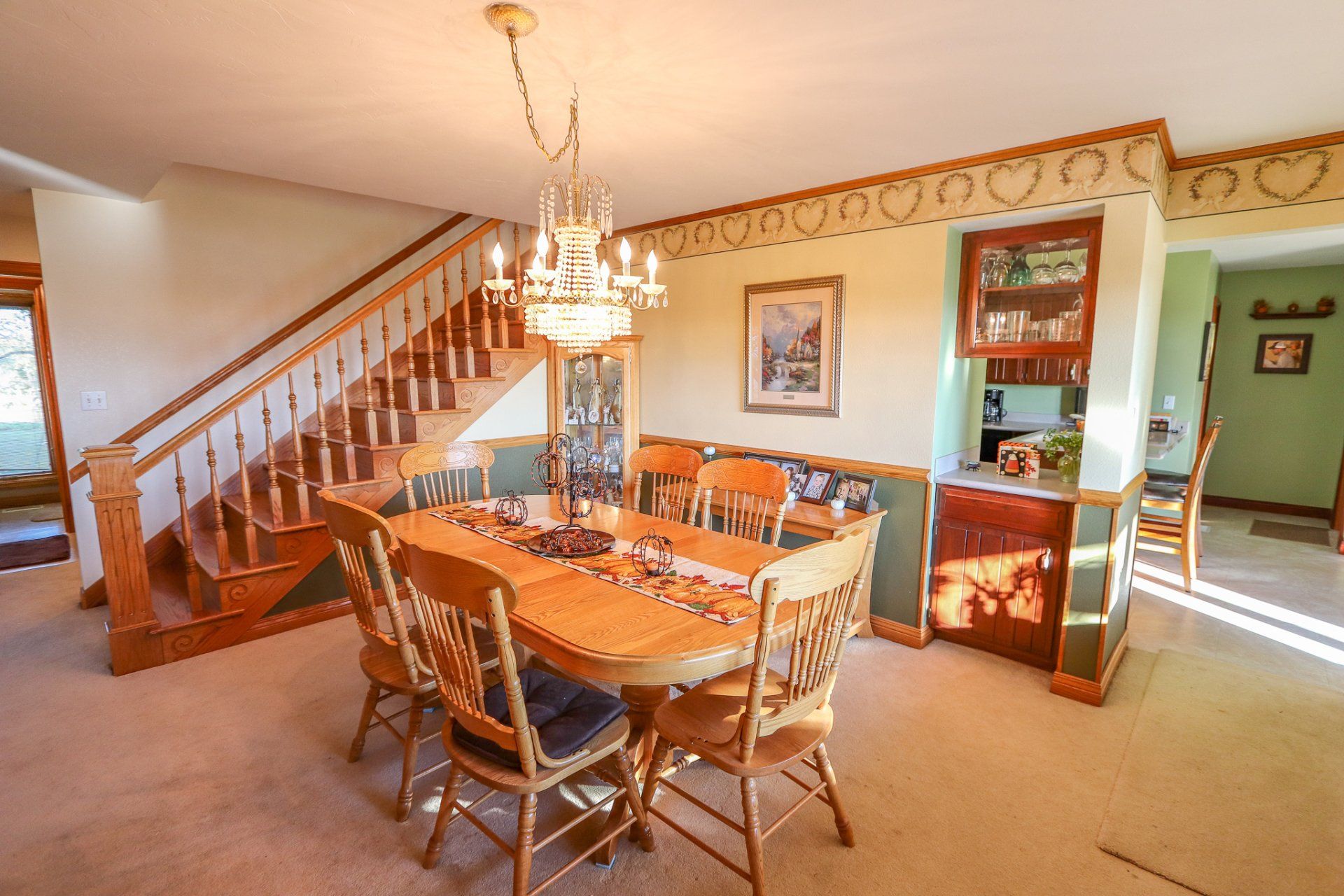 A dining room with a table and chairs and a chandelier.