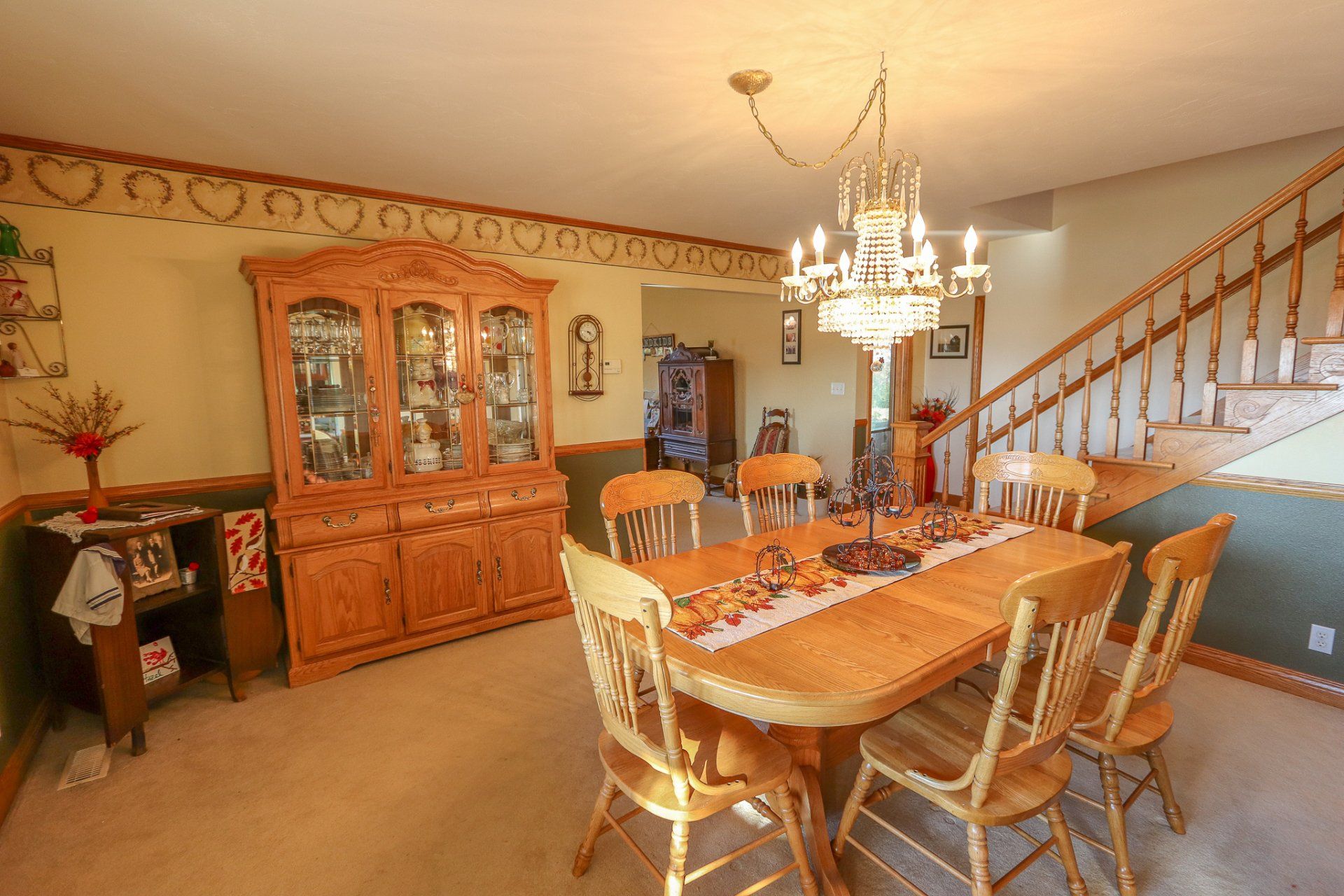 A dining room with a table and chairs and a chandelier.