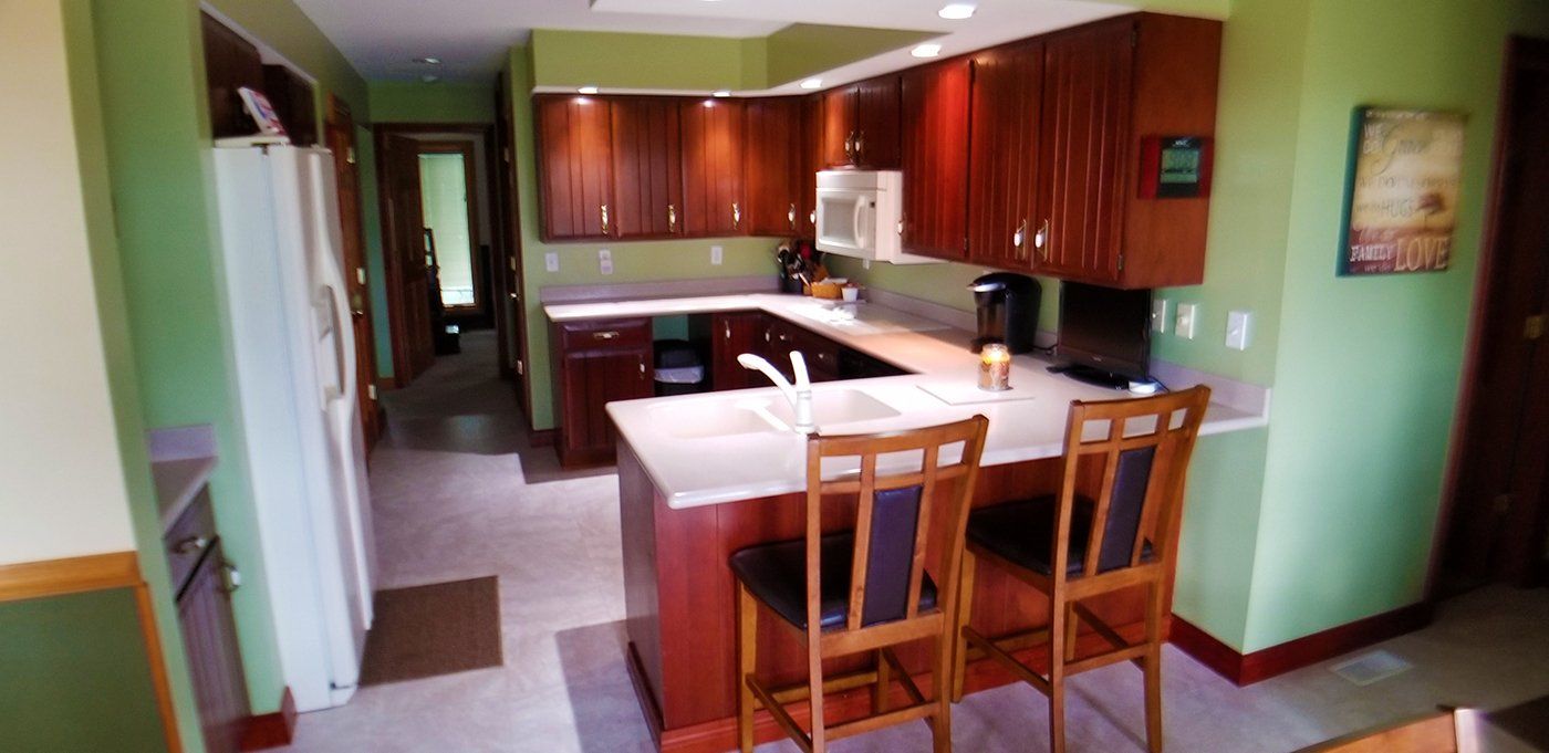 A kitchen with wooden cabinets and a white refrigerator