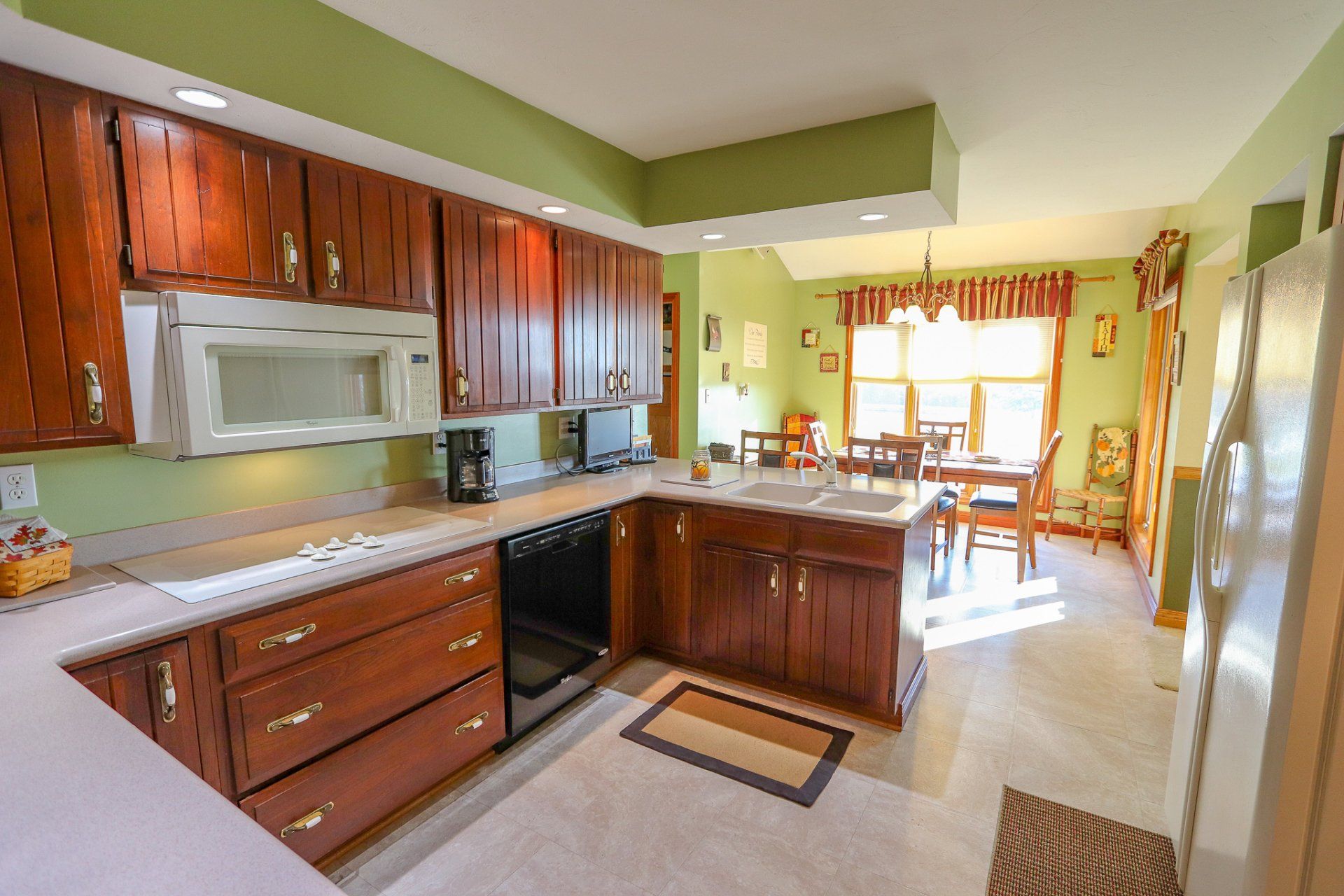 A kitchen with wooden cabinets and stainless steel appliances