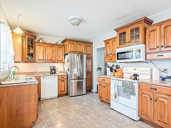 A kitchen with wooden cabinets and stainless steel appliances.