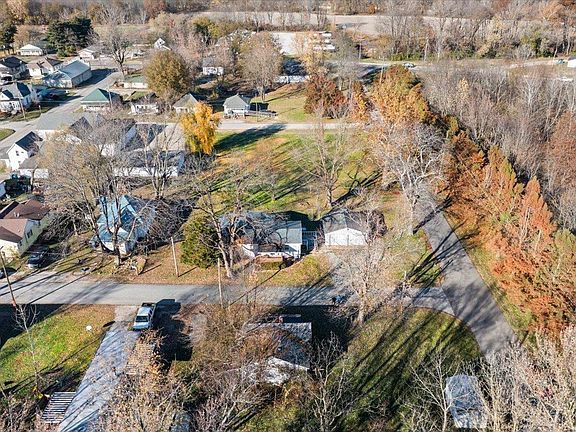 An aerial view of a residential area with houses and trees.