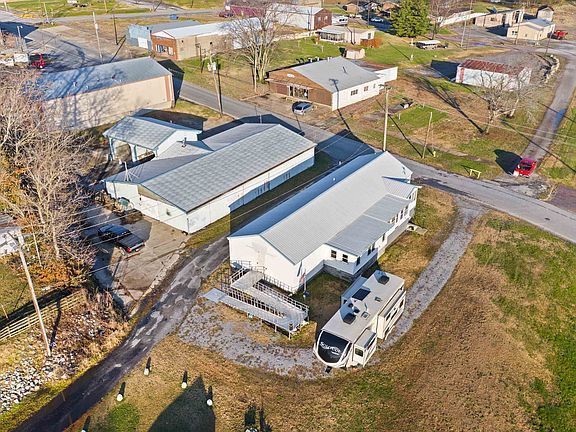 An aerial view of a building with a trailer parked in front of it.