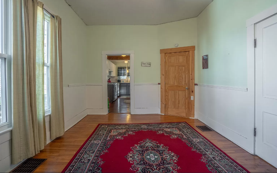 There is a red rug in the middle of the room.