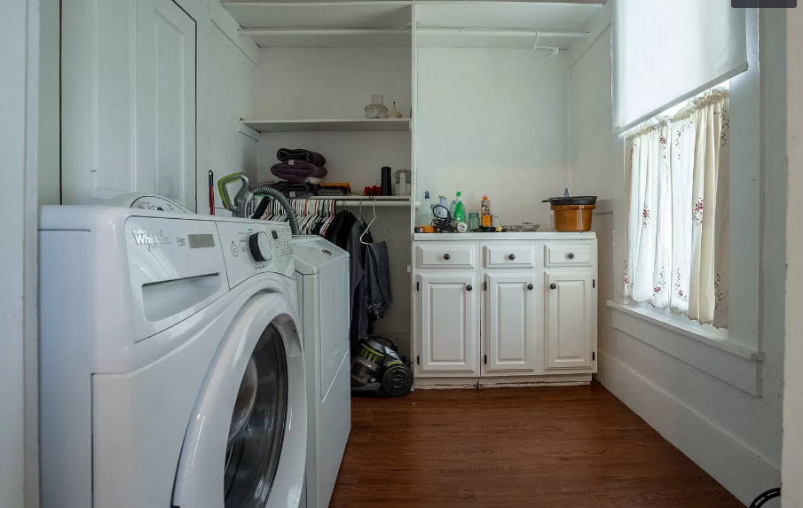 A laundry room with a washer and dryer and a window.