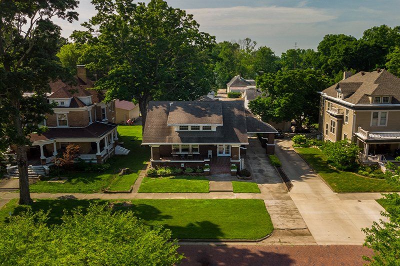 An aerial view of a residential neighborhood with houses and trees