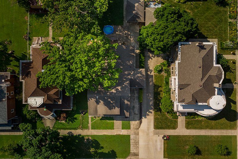 An aerial view of a residential area with houses and trees
