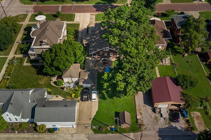 An aerial view of a residential neighborhood with lots of houses and trees.