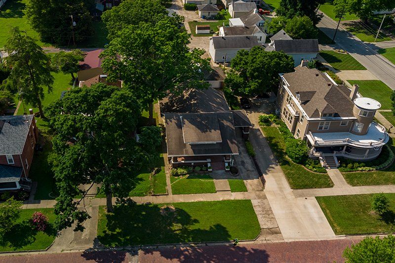 An aerial view of a residential neighborhood with lots of houses and trees.
