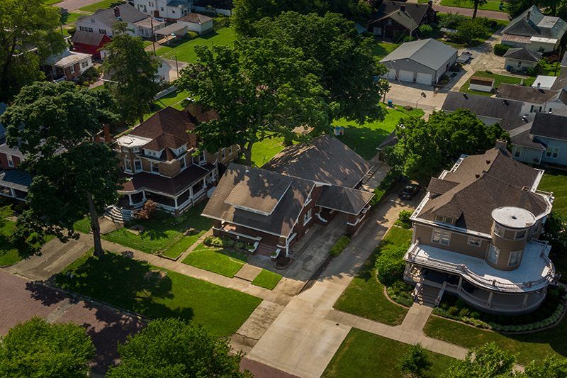 An aerial view of a residential neighborhood with lots of houses and trees.