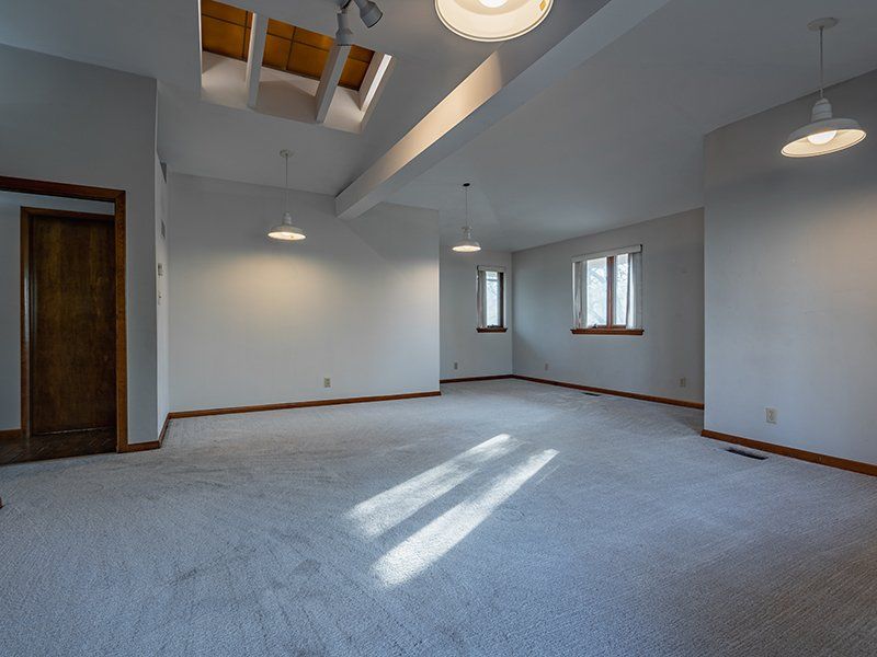 A large empty room with a skylight in the ceiling