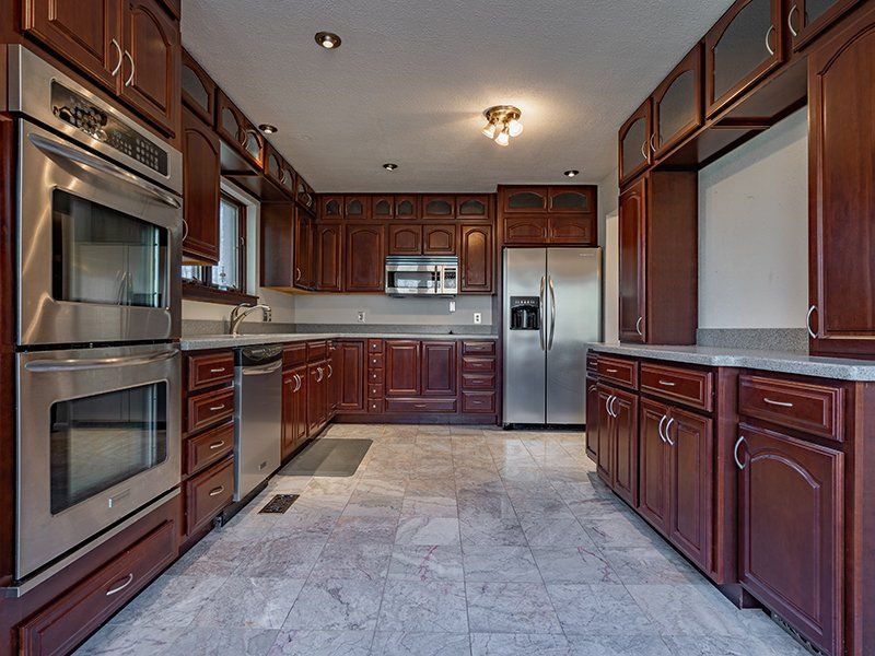 A kitchen with stainless steel appliances and wooden cabinets