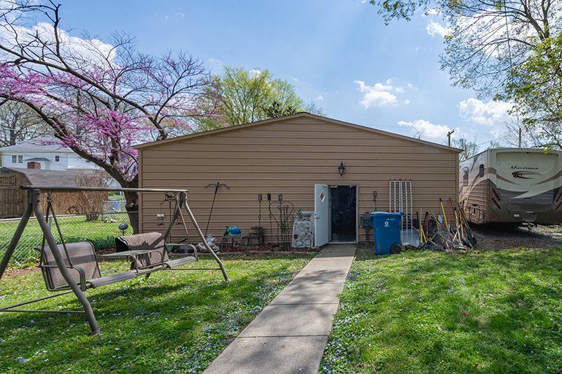 A house with a rv parked in front of it.