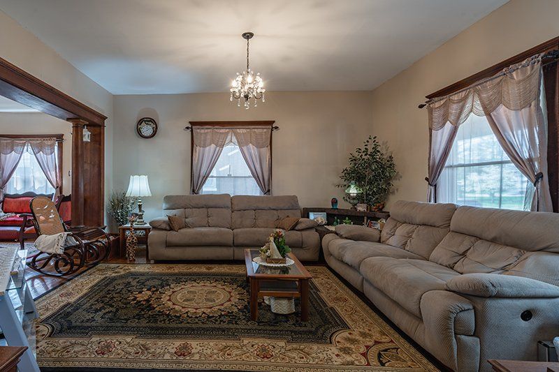 A living room filled with furniture and a rug.