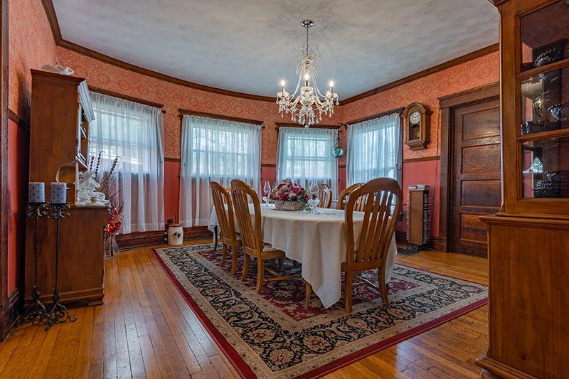 A dining room with a table and chairs and a chandelier.