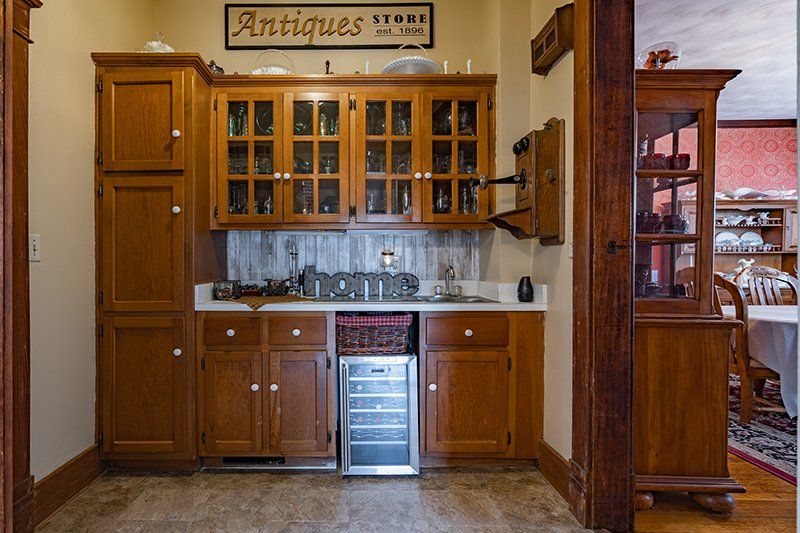 A kitchen with a sign that says antiques store